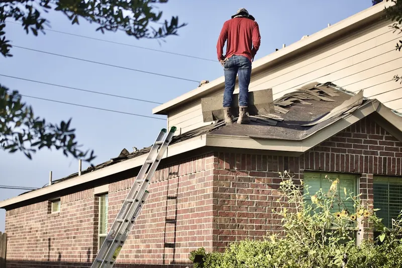 Professional roofer working on a residential roof in Dewy Rose